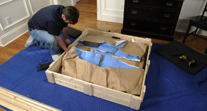 man packing furniture